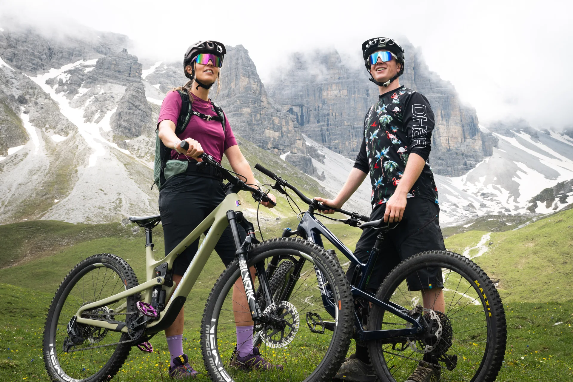 Two mountain bikers against an alpine mountain backdrop